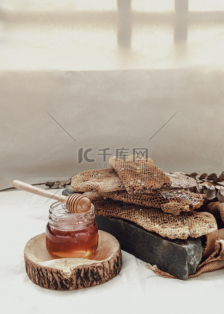 美味的蜂蜜从玻璃瓶上的新鲜蜂窝