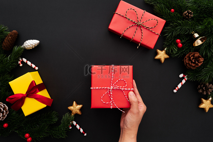 带松树和圣诞装饰的手持圣诞礼盒
