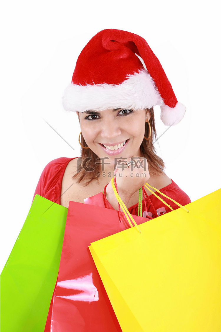 “戴着圣诞帽的快乐女人拿着购物