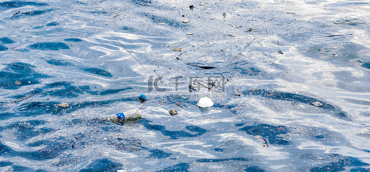 漂浮在海滩边的塑料瓶装水和其他