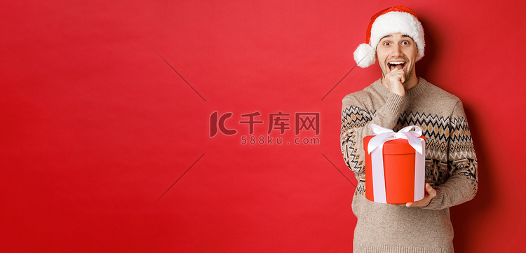 戴着圣诞帽和圣诞毛衣的帅哥兴奋