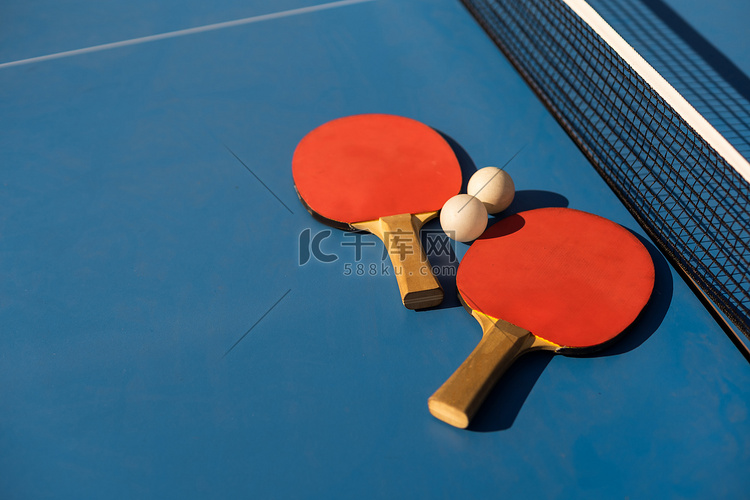 乒乓球乒乓球桨和蓝板上的白球。