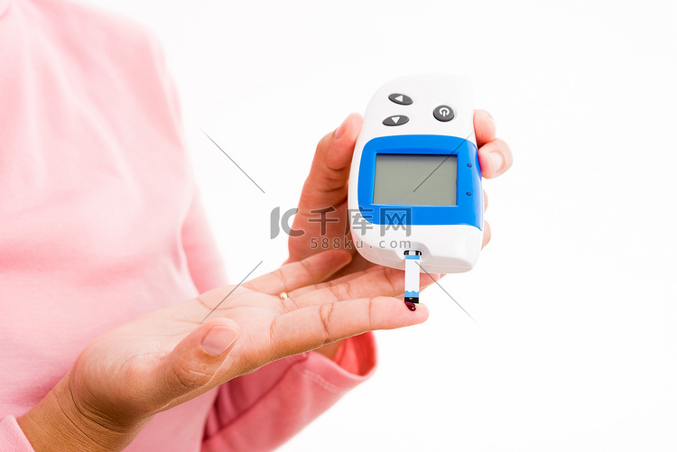 女人用手指上的血测量葡萄糖测试