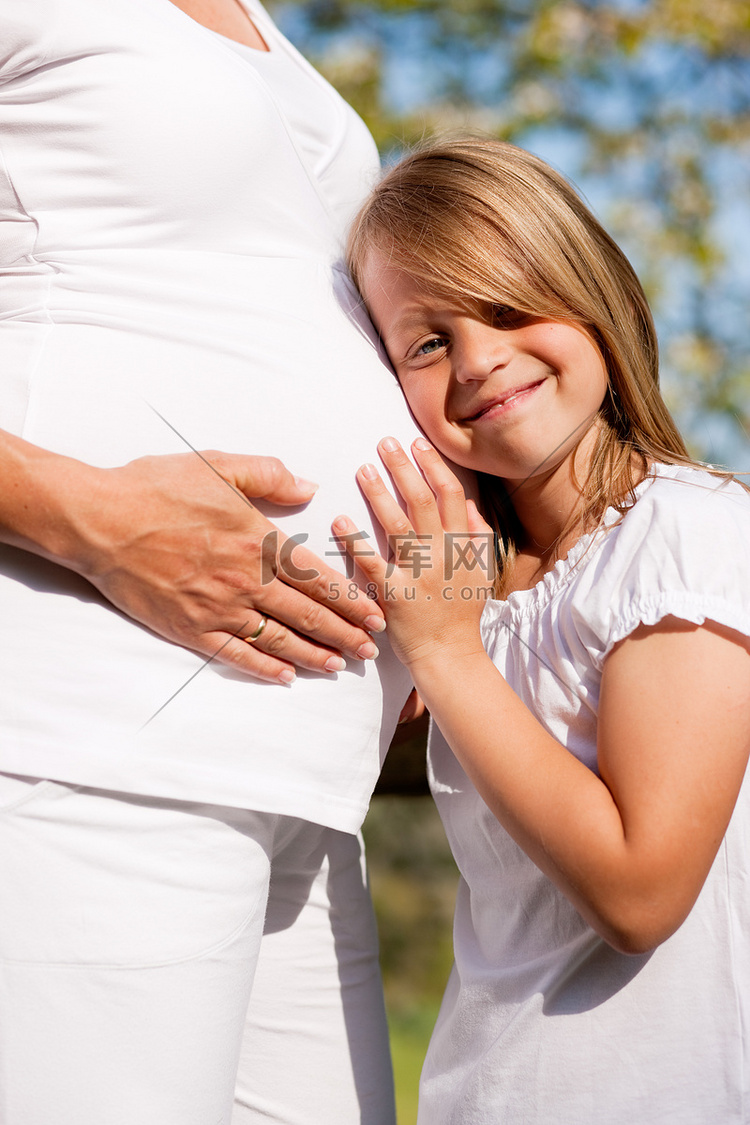 怀孕-触摸怀孕母亲腹部的女孩