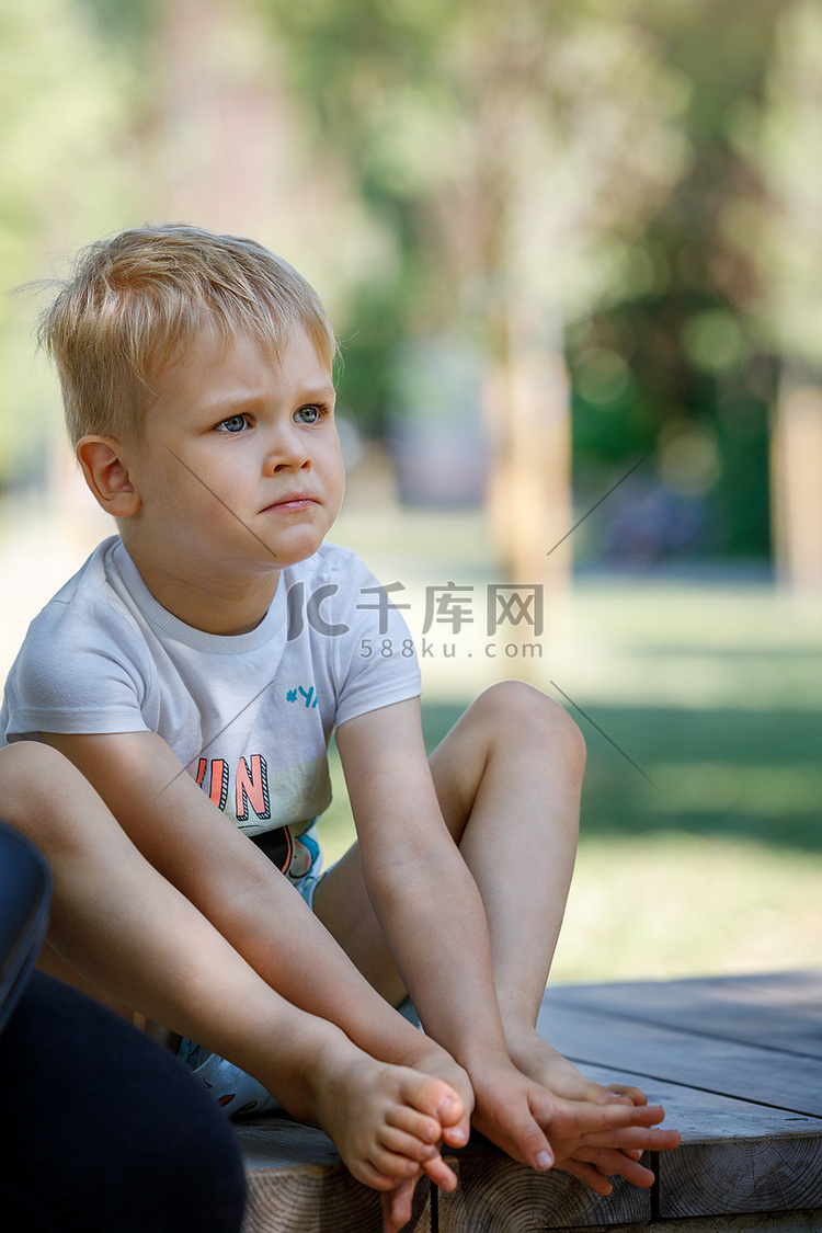 夏日公园里一个悲伤的小男孩的画