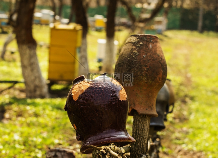 挂在木栅栏上的旧传统粘土水罐。