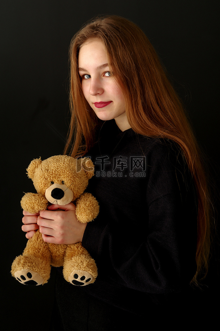 黑色背景上有泰迪熊的少女。