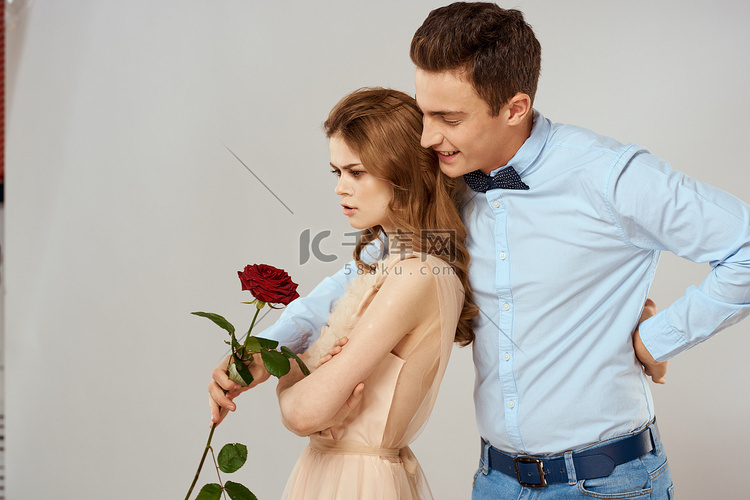 快乐的年轻夫妇浪漫拥抱关系红玫