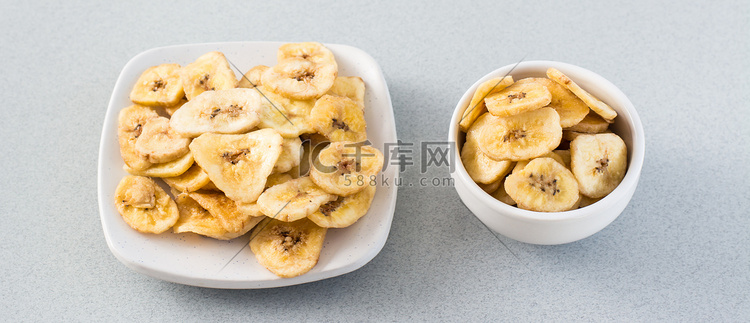 烤香蕉片放在白色的碗和桌子上的