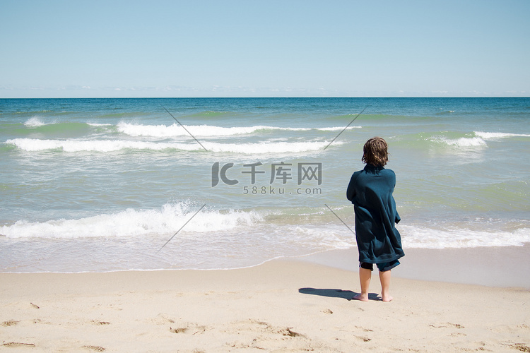 男孩站在沙滩上