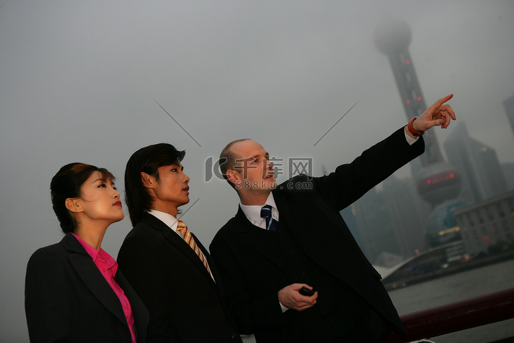 阴雨天外滩黄浦江边三位中外商务