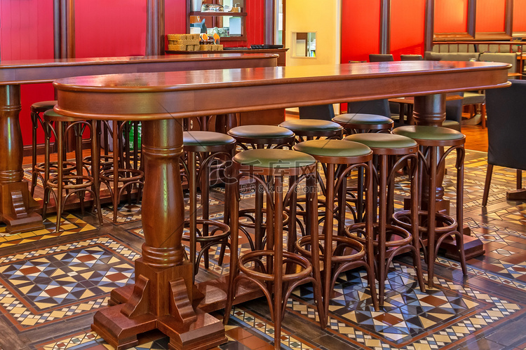 酒吧里一排木高椅在酒吧的桌子前