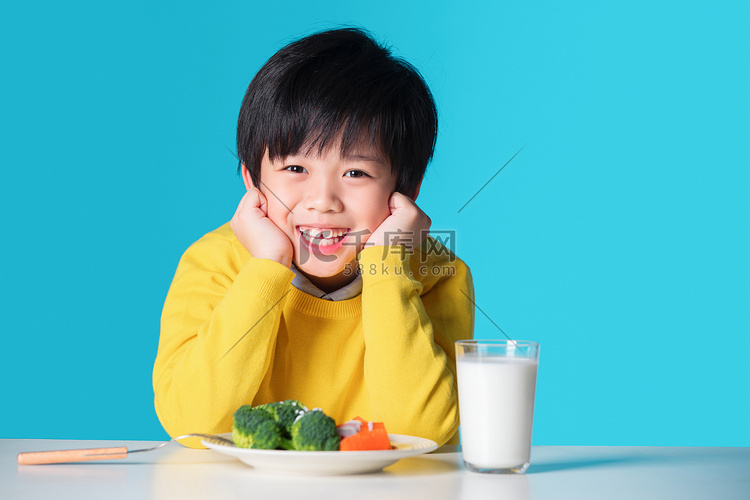 快乐的小男孩吃蔬菜