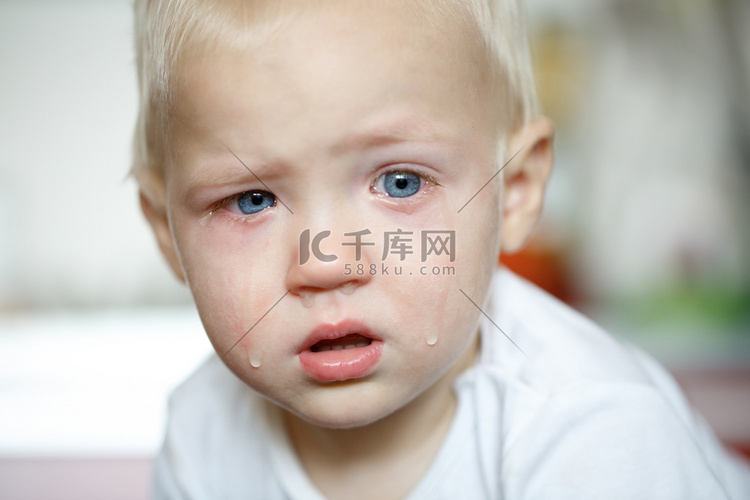 Small, crying toddler in pain
