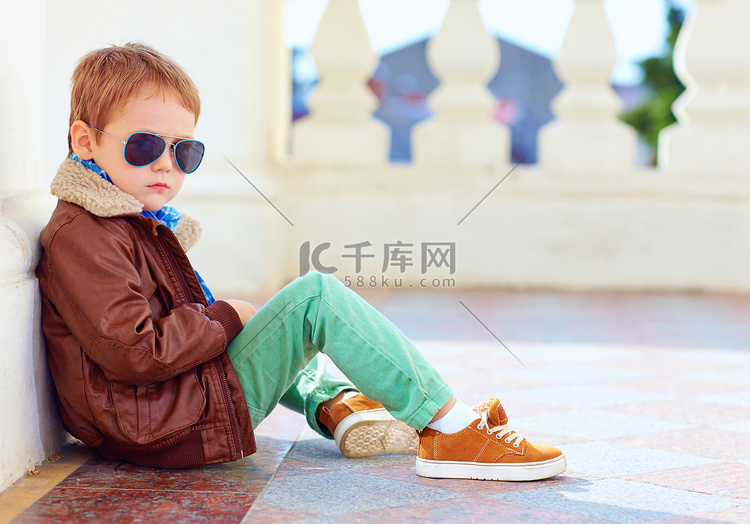 可爱的时尚男孩夹克和胶皮鞋