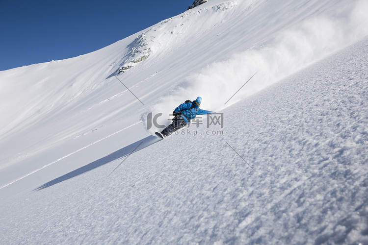 男子单板滑雪运动员飞驰而下陡峭