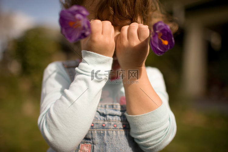 年轻的女孩在面前捧着鲜花