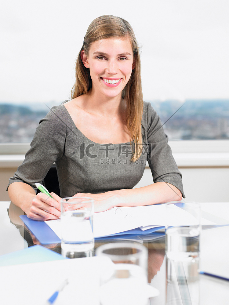 一名妇女正在整理文件面带微笑