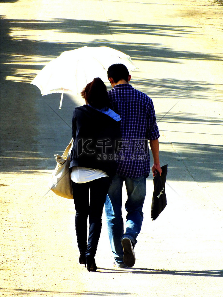 一对撑伞走路的情侣夫妻