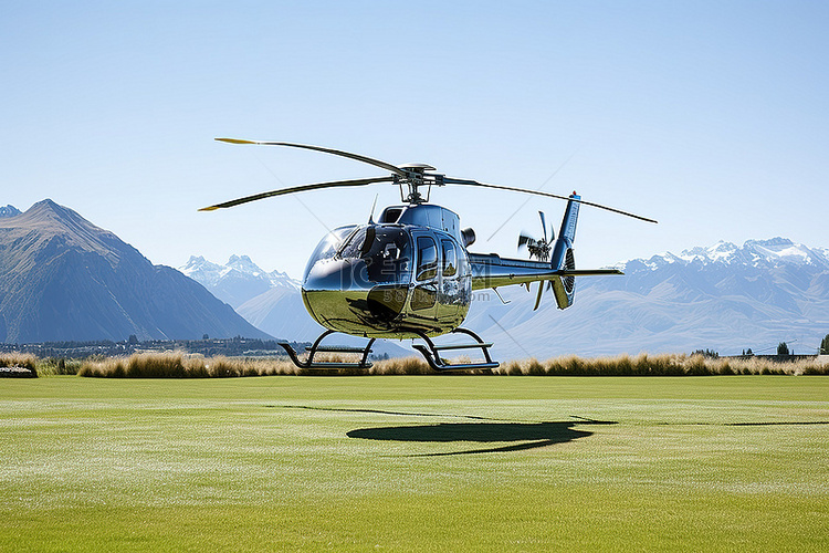 一架直升机飞越草地，背景是山脉
