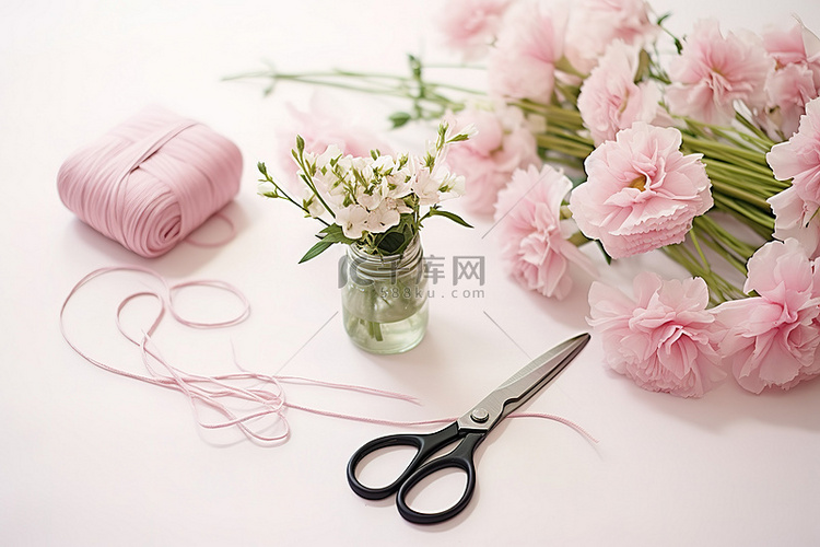 一把剪刀旁边有粉色的花朵和粉色