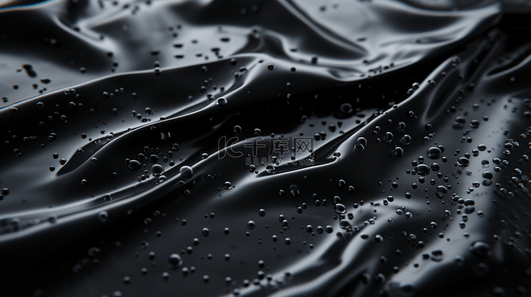 黑色质感装饰布上水珠水流的背景