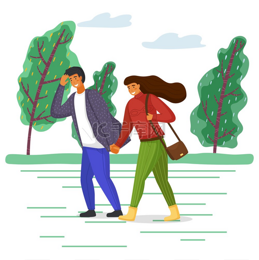 穿着休闲服的女人和男人在刮风的天气里走在公园的路上，女孩的头发在风中飘扬。图片