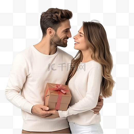 男朋友看着他的圣诞礼物，而他的女朋友给了他一个吻图片