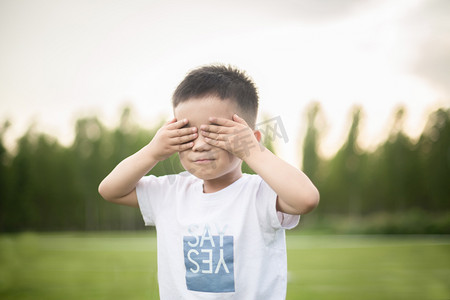 小孩子瘦摄影照片_双手捂眼睛的小孩子