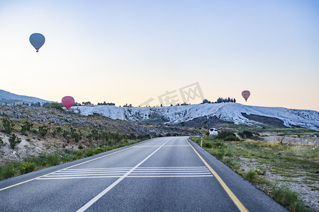 田野公路上空热气球摄影图