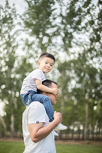 小孩肩膀摄影照片_坐在肩膀上蒙爸爸眼睛的孩子