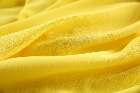 质感黄色背景摄影照片_黄色雪纺布料
