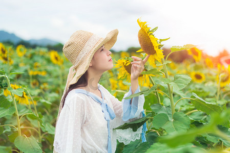 沙滩人物摄影照片_少女在挑逗向日葵