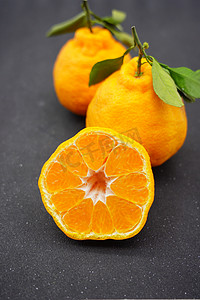 黄色质感海报摄影照片_丑橘水果摄影图