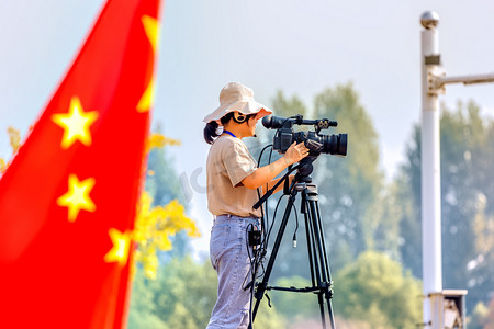 中秋国庆双节同庆摄影照片_国旗人物和摄像机