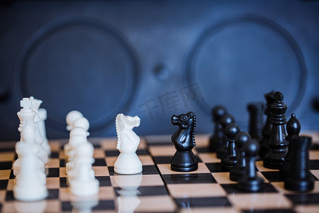 击壤游戏图摄影照片_国际象棋棋盘上黑白棋子对战