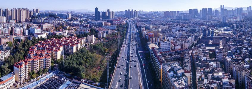 城市公路摄影照片_昆明白天菊华立交桥城市航拍全景车流摄影图配图