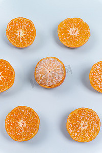 砂糖摄影照片_水果排列切开的砂糖小橘子新鲜食材摄影图配图