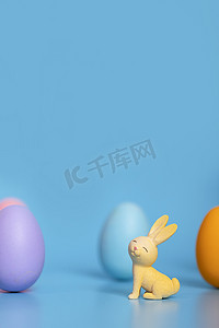 主题海报背景摄影照片_复活节节日兔子彩蛋创意蓝色背景静物摄影图配图