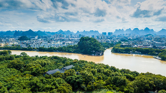 台风提醒摄影照片_航拍实拍城市江水洪峰过境夏季暴雨后城市建筑群