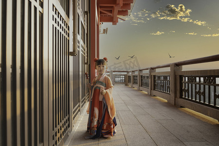 大闹天宫字体摄影照片_天宫仙女过年咯夕阳吃糖葫芦的女孩天上宫阙吃糖葫芦摄影图配图