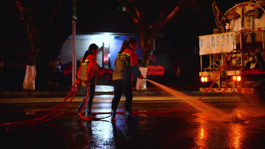 环卫工人日海报摄影照片_夜晚下的环卫工人清洁城市道路