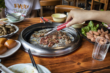 美食摄影照片_聚餐白天烤肉餐馆美食实拍摄影图配图