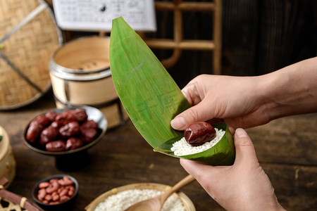 初一初五摄影照片_美食端午节妈妈家里包粽子摄影图配图