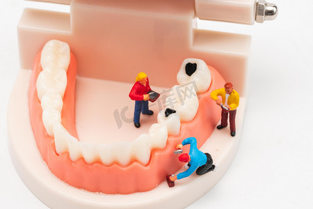 牙齿护理素材摄影照片_口腔健康白天龋齿牙齿模型室内看牙摄影图配图