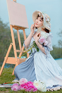 文艺清新白天穿着萝莉裙的写生美女户外草坪摆拍摄影图配图