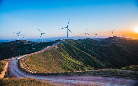 自然风景摄影照片_新能源风力发电傍晚风车群山山峰落日余晖摄影图配图