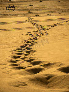 漫天黄沙摄影照片_沙漠美景白天鸣沙山沙漠中长长的脚印摄影图配图