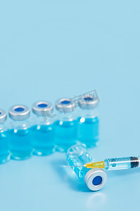 疫苗医疗创意医用蓝色背景摄影图配图
