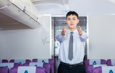 空乘白天男乘务员客舱内部展示安全通道摄影图配图